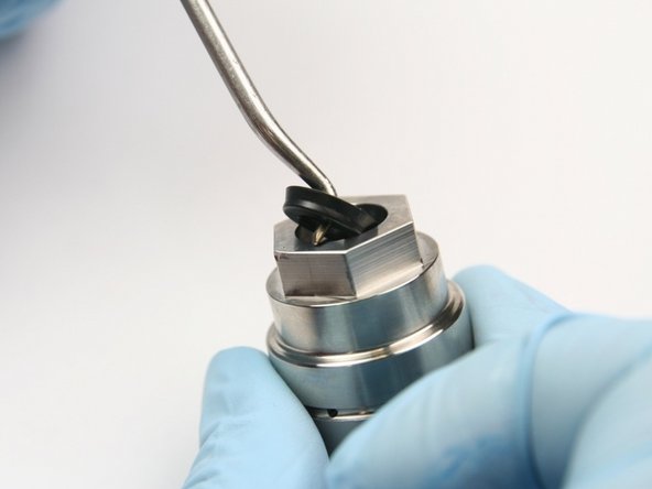 Remove the wiper from the top of the bearing half of the swivel housing with a pick.