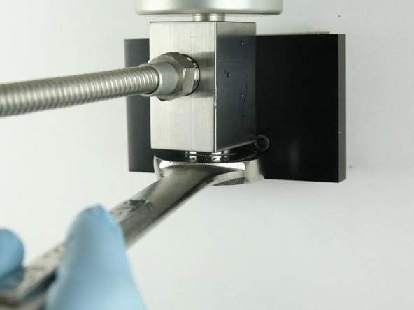 Loosen the high-pressure gland fitting using a 1-1/8&quot; wrench.