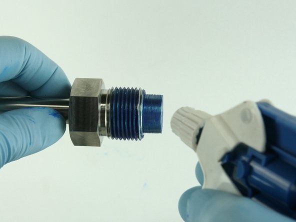 Clean the valve nut threads and the top of the   nozzle tube of all Blue Goop.