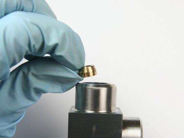 Put the second back-up ring into the  swivel housing behind the high-pressure seal assembly with the larger face down.