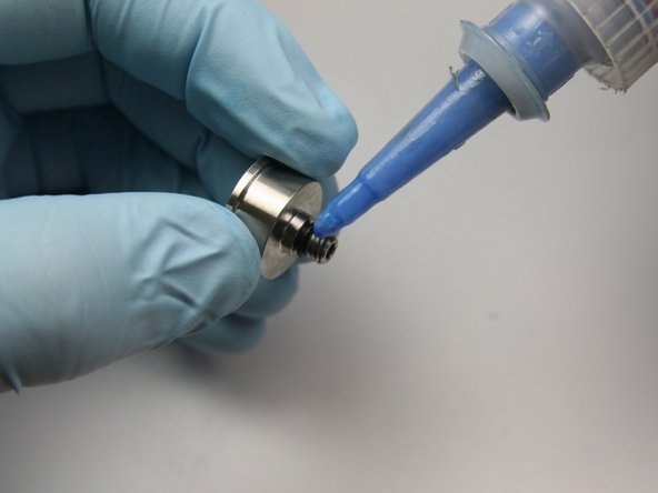 Apply a small amount of blue loctite to the threads of the poppet retainer.