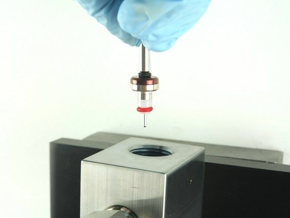 Put the point of the valve stem into the valve body.