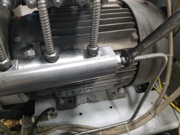 Remove high-pressure tube from manifold using a 13/16" open end wrench