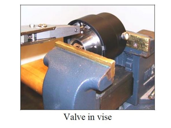 Twist the actuator cap until the four screw holes line up with the holes in the retainer.