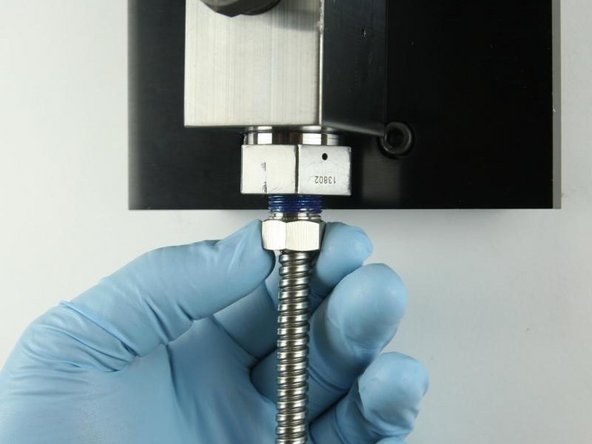 Thread in the high-pressure tubing to the bottom of the high-pressure gland fitting.