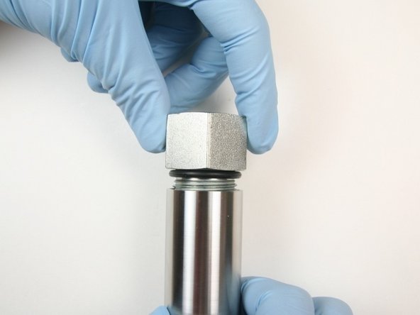 Unthread the adapter fitting from the  actuator housing.