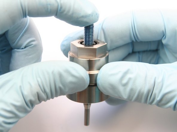 Remove the swivel shaft from the bearing half of the swivel housing by pushing down through the wiper.