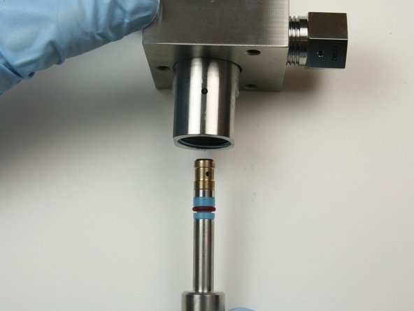 Put the bleed-down valve tool with the parts into the bottom of the valve body until the tool reaches the bottom of the valve.