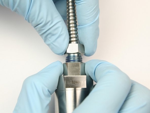 Thread high-pressure gland into swivel nut.