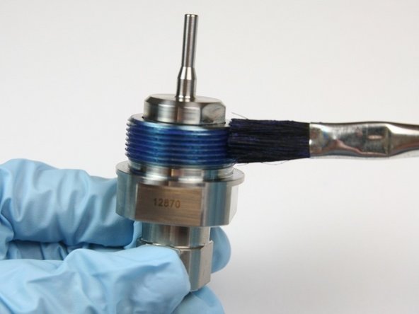 Apply Blue Goop to threads of bearing half of swivel housing