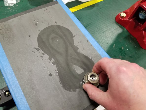 Secure lapping paper to a hard, flat surface such as the glass plate that came with your system, or a granite surface plate