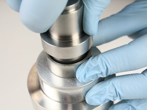 Put the non-stepped end of the push tool into the sleeve and press the high-pressure seal into the high-pressure cylinder until it bottoms out.