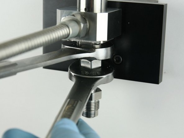 Tighten adapter into valve body using a 1&quot; and 13/16&quot; wrench.