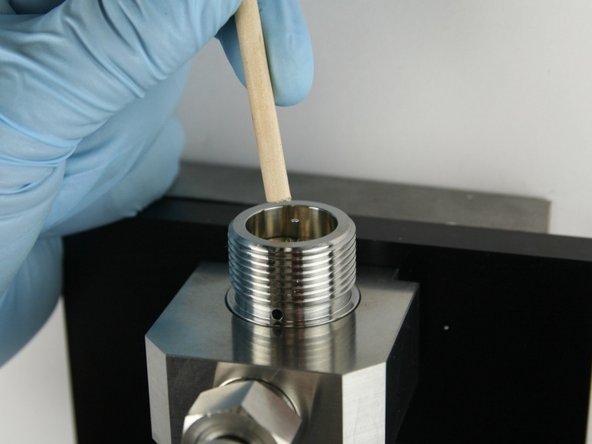 Use the dowel to push the needle in the valve body until the needle bearing bottoms out.