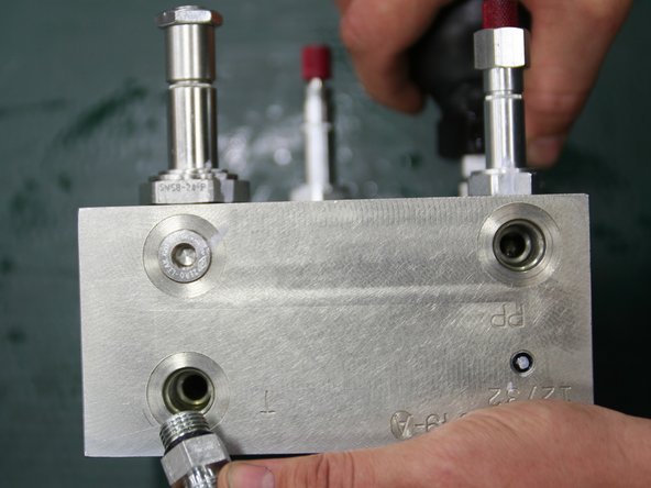 Install straight fittings (removed from old manifold) into ports, labeled T and PP, on bottom of new manifold.