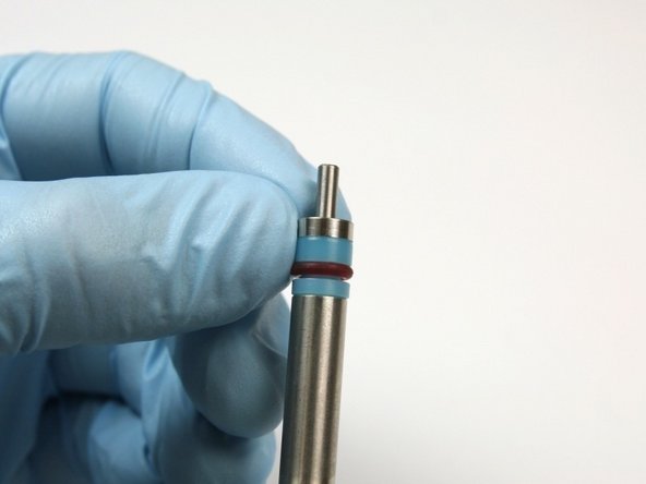 Slide the hoop, with the sharp edge first, on to the bleed-down valve tool behind the high-pressure seal.