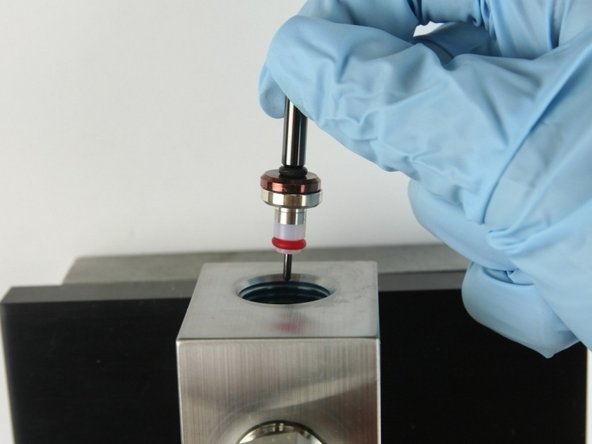 Put the point of the valve stem into the valve body.