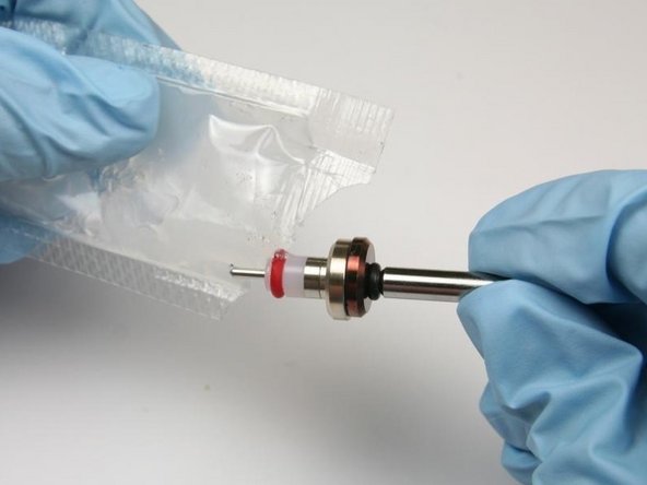 Apply high vacuum grease to the outside diameter of the high-pressure valve seal.