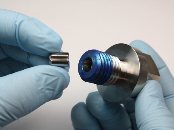 Place the poppet valve into the high-pressure sealing head gland with the solid end away from the poppet pin.