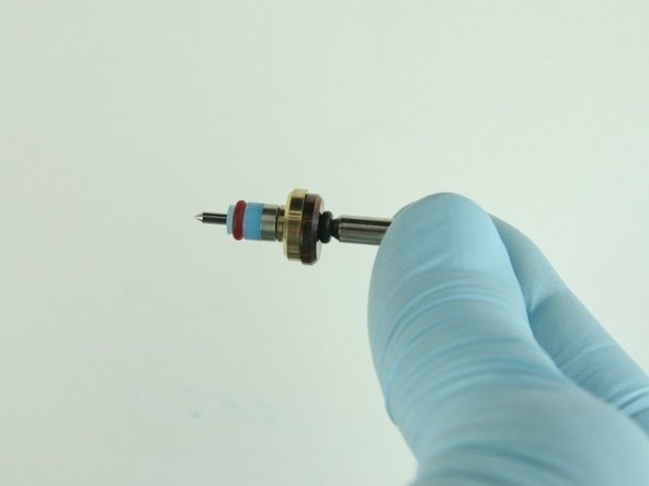 Slide the hoop and the high-pressure valve seal onto the valve stem with the hoop towards the brass back-up ring.