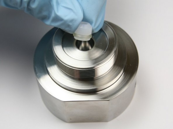 Put the high-pressure seal (O-ring side first) into the cavity of the seal half of the swivel housing.