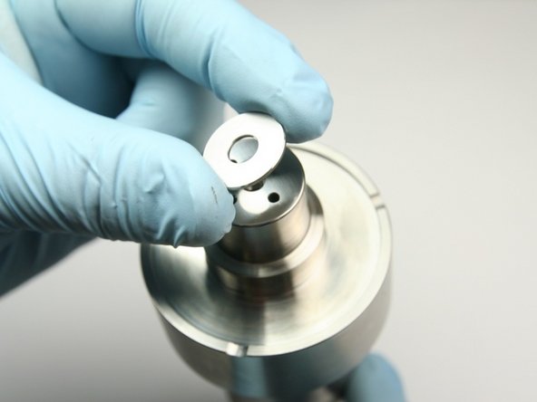 Set the new inlet poppet so it is centered on the top of the sealing head body (covering 4 holes).