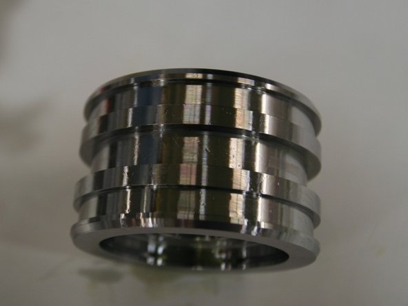 Visually inspect the piston for any scratches or blemishes. If damaged, replace the piston.