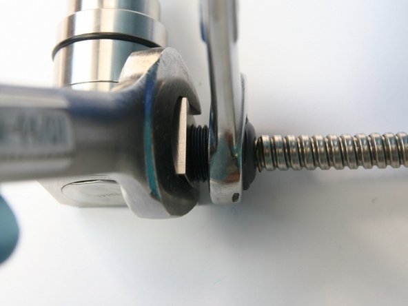 Tighten the high-pressure gland nut with 3/4&quot; and 5/8&quot; wrench.