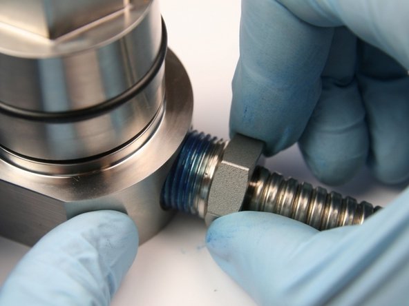 Unthread the high-pressure gland from the seal half of the swivel housing.