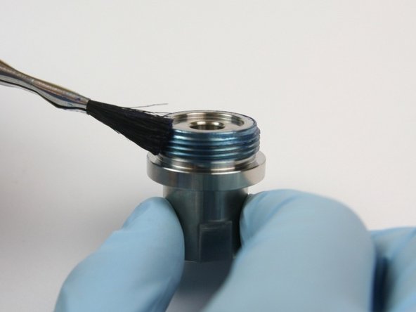 Apply a layer of Blue Goop to the threads of the seal half of the swivel housing.