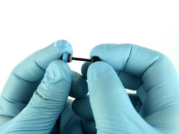 With the O-ring towards the point of the poppet stem, slide the high-pressure valve seal on to the poppet stem.