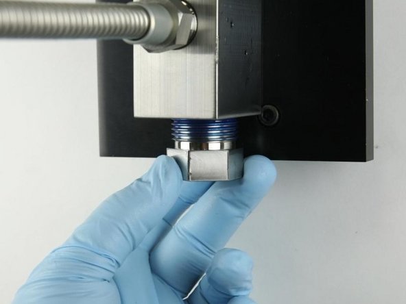 Unthread the high-pressure gland fitting from the valve body.