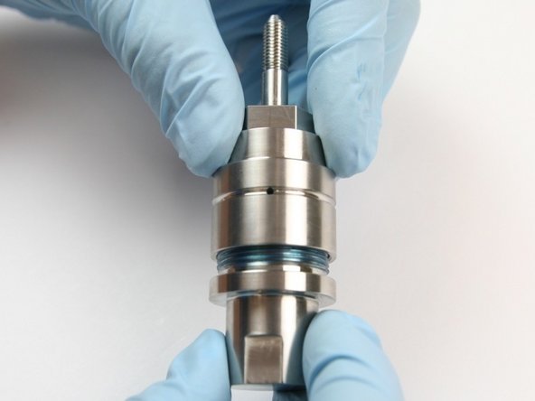 Thread the bearing half of the swivel housing onto the seal half of the swivel housing.