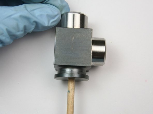 Use the included dowel to push the components out from the inside of the swivel housing.