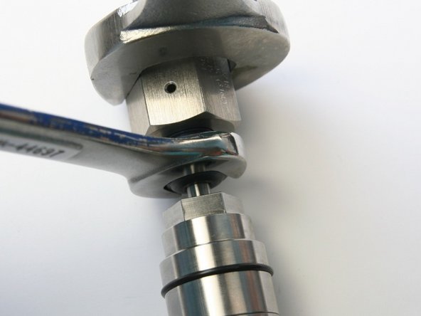 Tighten the high-pressure gland into the coupler using 1-1/16&quot; and 5/8&quot; wrench.