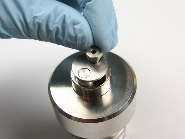 Put the retaining screw through the inlet poppet housing into the top of the check valve body.