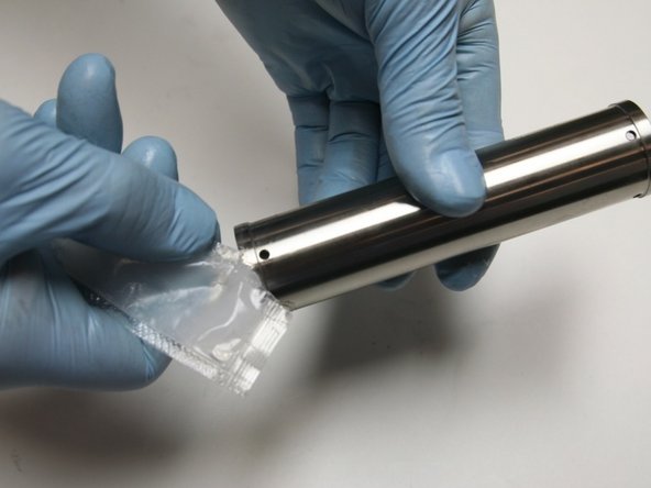 Apply high vacuum grease to both ends of the spacer tube.