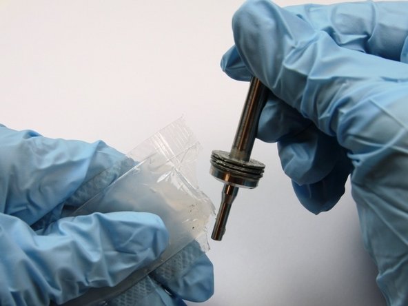 Apply high vacuum grease to the short end of the swivel shaft.