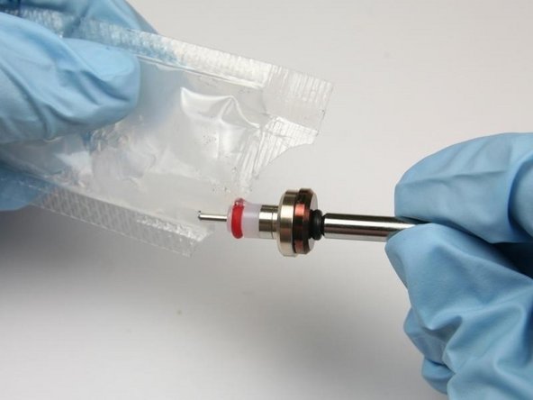 Apply high vacuum grease to the outside diameter of the high-pressure valve seal.