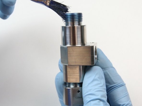 Apply a layer of blue goop to the external threads of the valve body.