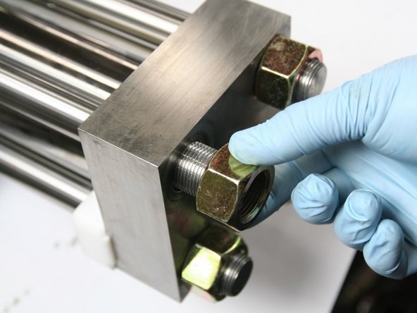 Thread and hand-tighten nuts onto studs using a cross pattern