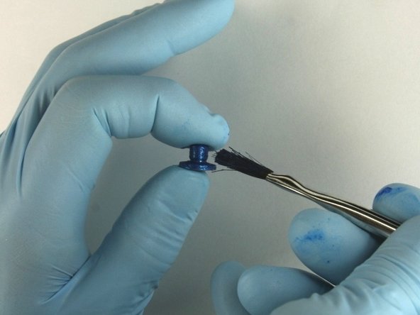 Apply Blue Goop to all surfaces of the seat.