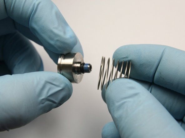 Place the inlet compression spring on the poppet retainer.