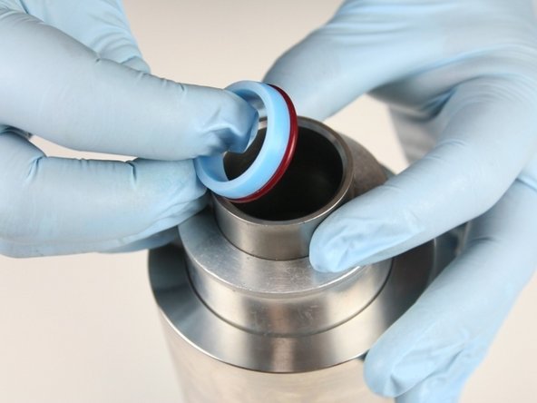 Put the high-pressure seal into the sleeve with the o-ring down.