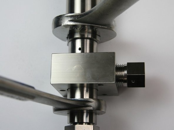 Tighten the actuator housing to the  valve body using 1-1/16" and 7/8" wrench.