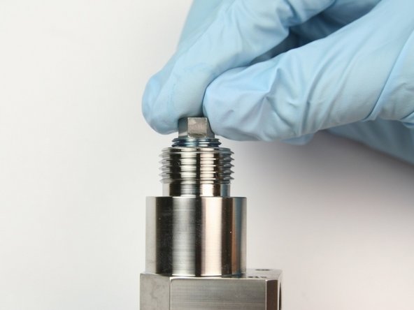 Thread in back-up screw into top of bleed down valve body