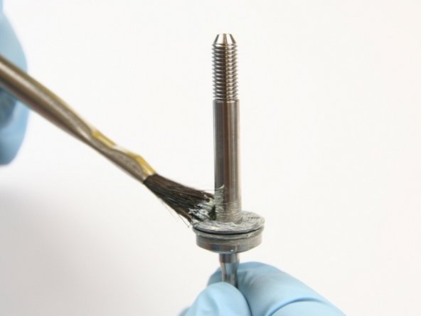 Apply lithium grease to the top of the thrust bearing.