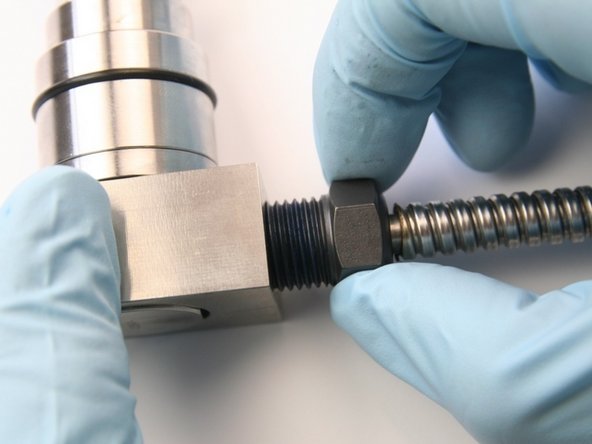 Thread the high-pressure gland into the swivel collar.