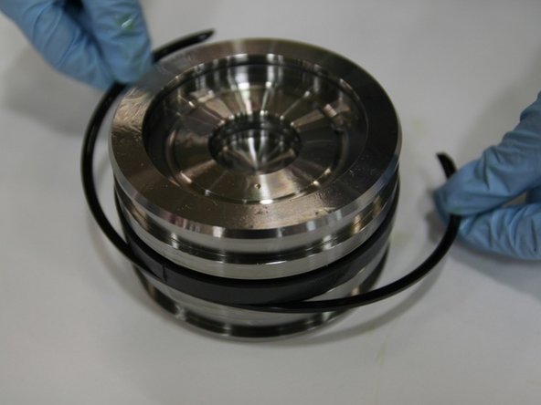 Put the second split ring onto the middle groove with the rounded side facing inward towards the T-seal.