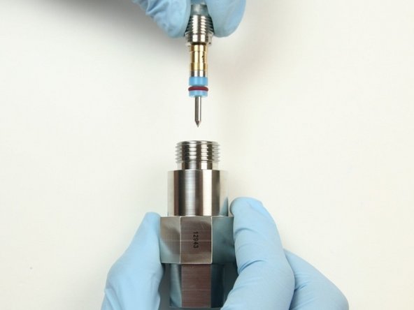 Insert the high pressure needle assembly into the top of the bleed down valve body with the point first.